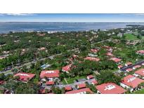 A bird's-eye view of the neighborhood, showcasing the lush landscaping and proximity to the bay at 3500 El Conquistador Pkwy # 128, Bradenton, FL 34210