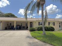 Charming single-story home with a well-maintained lawn and a beautiful palm tree in the front yard at 390 301 W Blvd # 2C, Bradenton, FL 34205