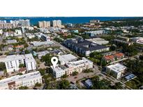 An aerial view shows the proximity to the water, a red car, and the location marker for the listing at 525 N Orange Ave # 302, Sarasota, FL 34236