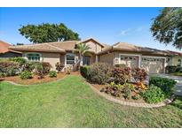 Beautiful home showcasing meticulously maintained landscaping and a well manicured lawn at 5584 Eastwind Dr, Sarasota, FL 34233