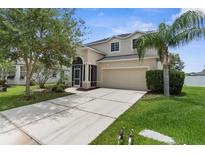Charming two-story home with a well-manicured lawn and a spacious two-car garage at 5981 Willows Bridge Loop, Ellenton, FL 34222