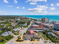 Coastal home boasts charming landscaping and easy access to the beach and nearby city amenities at 714 & 716 Apalachicola Rd, Venice, FL 34285