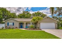 Charming single-story home with mature trees, manicured lawn, and a two-car garage at 8007 17Th Nw Ave, Bradenton, FL 34209