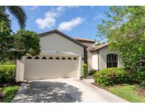 Charming home with a two-car garage, tile roof, and lovely landscaping at 8078 Stirling Falls Cir, Sarasota, FL 34243