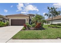 Charming single-story home with a well-manicured front yard and lush landscaping at 208 Ariano Ave, Nokomis, FL 34275
