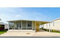 Inviting single-story home featuring a screened-in porch and covered carport at 3222 Sycamore Ter, Sarasota, FL 34237
