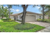 Charming single-story home with a tile roof, well-maintained landscaping, and a two-car garage at 3317 Highlands Bridge Rd # 61, Sarasota, FL 34235