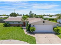 Charming single-story home with a well-maintained lawn, inviting curb appeal, and two car garage at 3621 S Lockwood Ridge Rd, Sarasota, FL 34239