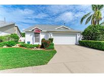 Charming home with well-manicured lawn, mature landscaping, and a two-car garage at 4227 Placid Dr, Sarasota, FL 34243