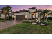Charming single-Gathering home featuring a two-car garage and beautifully landscaped front yard, perfect for curb appeal at 4720 Arpino Ct, Bradenton, FL 34211