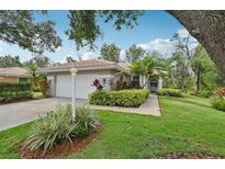 Charming home featuring a well-manicured lawn and inviting landscape at 6744 Hickory Hammock Cir, Bradenton, FL 34202