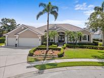 Attractive single-Gathering home featuring beautiful landscaping, an expansive driveway, and a two-car garage at 7513 Coventry Ct, Lakewood Ranch, FL 34202