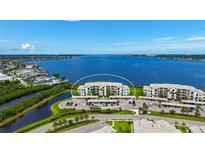 Panoramic aerial view of waterfront condo building with covered parking and stunning water views at 850 Tidewater Shores Loop # 108, Bradenton, FL 34208