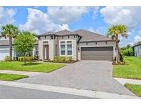 Charming one-story home with a paver driveway, two-car garage, and a well-manicured lawn at 926 Fernleaf Run, Bradenton, FL 34212