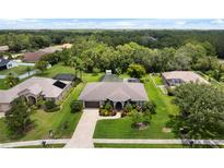 Expansive home boasts lush landscaping, screened pool, and generous green space at 1711 145Th E St, Sarasota, FL 34212
