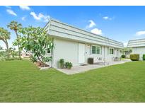 Charming single-story home with well-maintained lawn and inviting front patio seating area at 202 Bedford Trl # 120, Sun City Center, FL 33573