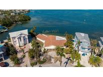 Waterfront home with dock, lush landscaping, and stunning bay views at 236 S Harbor Dr, Holmes Beach, FL 34217