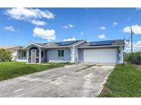 Charming single-story home with a well-maintained lawn, screened-in front porch, and solar panels at 3339 Duar Ter, North Port, FL 34291