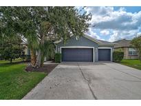 Charming single-story home featuring a well-manicured lawn and a two-car garage at 4360 85Th Avenue E Cir, Parrish, FL 34219