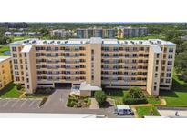Multi-story condo building with parking and beautiful landscaping on a sunny day at 4460 Fairways Blvd # 607, Bradenton, FL 34209