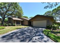 Charming single-story home featuring a two-car garage and a well-maintained lawn with mature landscaping at 4555 Chandlers Forde # 47, Sarasota, FL 34235