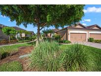 Charming single-story home with a well-manicured lawn, mature trees, and a two-car garage at 5866 Cavano Dr, Sarasota, FL 34231