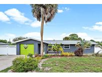 Charming single-story home with a well-manicured front yard and mature landscaping at 7355 Cass Cir, Sarasota, FL 34231
