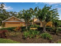 Charming home with beautiful landscaping, flowering trees, and a two-car garage in a tranquil setting at 1808 Coquina Dr, Sarasota, FL 34231