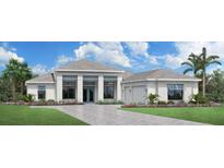 Elegant one-story home featuring a manicured lawn, paver driveway, and a two-car garage, perfect for comfortable living at 2504 Waterfront Cir, Sarasota, FL 34240