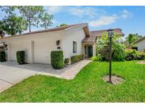 Charming single-story home with well-maintained landscaping and an attached two-car garage at 3362 Sandleheath # 12, Sarasota, FL 34235
