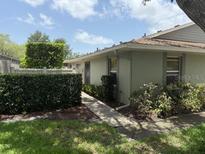 Charming single-story home with manicured landscaping and a walkway leading to the entrance at 4176 Center Pointe Cir # 70A, Sarasota, FL 34233
