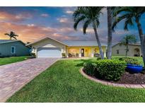 Charming single-story home with lush lawn, palm trees, and a welcoming front porch at 4508 Mangrove Point Rd, Bradenton, FL 34210