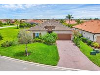 Inviting single-story home featuring a well-manicured lawn and a tiled roof with beautiful landscaping at 4524 Baltry Ct, Bradenton, FL 34211