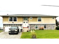 Charming two-story house with a unique stone base and a well-manicured lawn at 5111 Bay State Rd, Palmetto, FL 34221