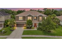 Beautiful two-story home with a well-manicured lawn and mature landscaping at 6306 Anise Dr, Sarasota, FL 34238