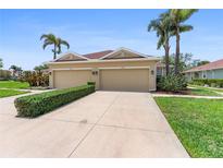 Charming villa with attached two-car garage and a well-manicured front yard landscape at 7403 Hamilton Rd, Bradenton, FL 34209