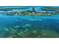 Stunning aerial view of waterfront property with turquoise water and lush landscaping at 767 John Ringling Blvd # 25, Sarasota, FL 34236