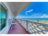 Enjoy beautiful ocean views from this condo balcony with seating and stylish white railings at 767 John Ringling Blvd # 25, Sarasota, FL 34236