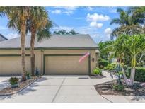 Charming home with a two-car garage, beautiful landscaping, and a manicured lawn at 8579 54Th Avenue E Cir, Bradenton, FL 34211