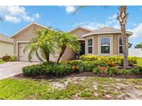 Charming single-story home with lush tropical landscaping and a paver driveway at 8937 Excelsior Loop, Venice, FL 34293