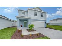 Charming two-story home with attached two car garage and front lawn landscaping at 13133 Bayberry Way, Parrish, FL 34219