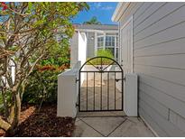 Charming courtyard gate with meticulous landscaping adds curb appeal to this lovely home at 1316 Perico Point Cir, Bradenton, FL 34209