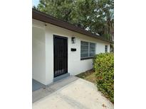 Inviting exterior showcasing a secure black iron door and well-maintained landscaping at 1354 22Nd St, Sarasota, FL 34234