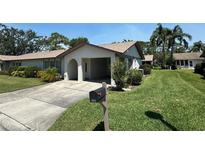 Charming one-story villa with a carport and well-manicured lawn at 1553 Stewart Dr # 513, Sarasota, FL 34232