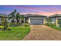 Charming one-story home with a brick driveway and lush, mature landscaping at 17910 Waterville Pl, Lakewood Ranch, FL 34202