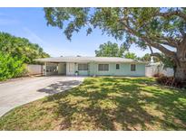 Charming single-story home with a well-manicured lawn and mature trees at 2275 Clematis St, Sarasota, FL 34239