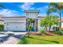 Charming single-story home with a well-manicured lawn and colorful landscaping, showcasing curb appeal at 3218 Big Sky Way, Bradenton, FL 34211