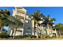 Beautiful building with balconies and stairs framed by palm trees on a sunny day at 3418 79Th Street W Cir # 202, Bradenton, FL 34209