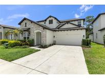 Beautiful two-story home with stone accents, well-manicured landscaping, and a two car garage at 3553 Secluded Ct, Sarasota, FL 34240