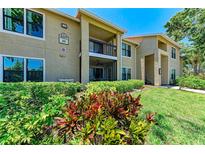 Beautiful two-story condo building with manicured landscaping and inviting outdoor spaces and balcony at 4057 Crockers Lake Blvd # 15, Sarasota, FL 34238
